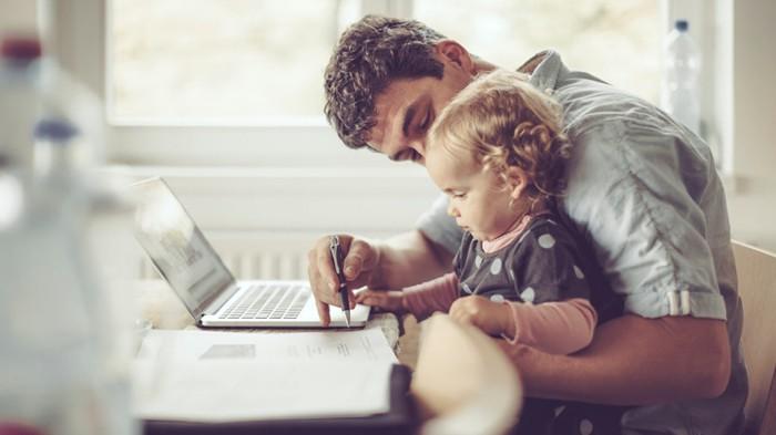 man playing on the computer with his son