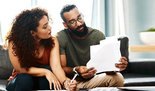 Keeping you and your finances ready for the unexpected (man and woman looking at papers)