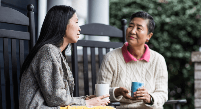 Two women sitting with a cup